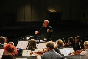 Photo by Linnea Ritchie. Daniel Culver conducts the Augustana Symphony Orchestra during rehearsal on Dec. 1. The orchestra will perform on Dec. 5 and 6 during the “Christmas at Augustana” annual concert. It will perform alongside other Augustana ensembles, including the Wennerberg Men’s Chorus and the Augustana Brass Ensemble.  