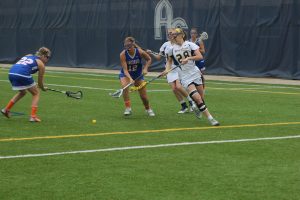 Junior attacker Rebecca Pollard lunges for the ball during the Vikings home NCAA appearance against Concordia Wisconsin. 