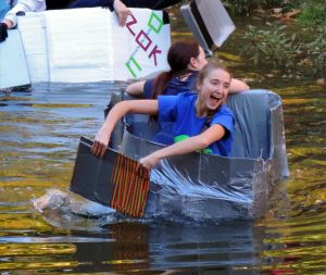 Students participate in the cardboard regatta races in the Augustana Slough. Photo by Christine Beach. 