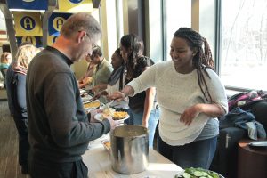 Senior Victoria Gillon serves mashed potatoes to Pastor Richard Priggie. Photo by LuAnna Gerdemann.