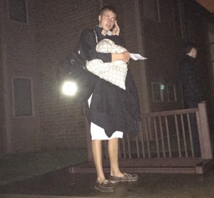 Junior Jon Elsey updates friends and family after collecting his belongings before finding a safe place to stay following the evacuation of his housing unit on Mar.15 following severe weather.